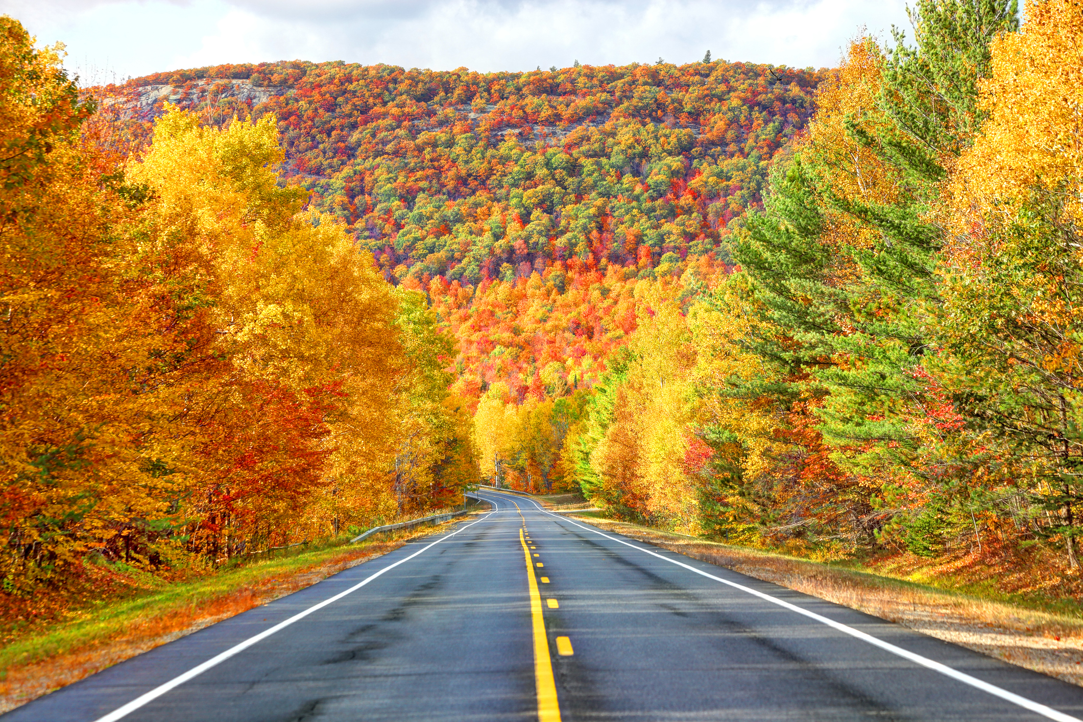 Scenic Autumn Road in the Adirondacks region of New York. The Adirondack Mountains form a massif in northeastern New York, United States