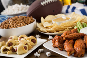 Hot wings, nachos, pigs in a blanket, beer, and popcorn, a tailgate party spread. Please see my portfolio for other food and drink images.
