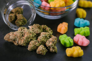 Trimmed marijuana nugs, with cannabis-infused, medicated edible gummy treats. An alternative method of consuming marijuana, medical & recreational.