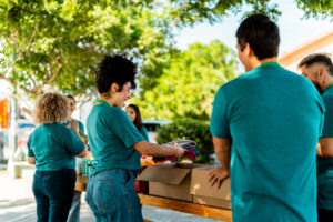 Volunteers talking and organizing donation boxes outdoors