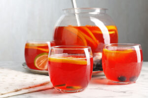 Fruity punch on white marble table, closeup. Refreshing drink