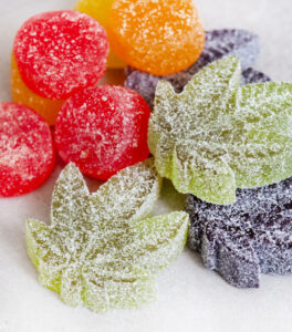 CBD and Cannabis infused jelly sweets on grey surface with copy space