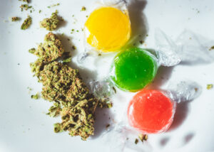 Marijuana buds and plastic wrapped THC/CBD infused hard candies