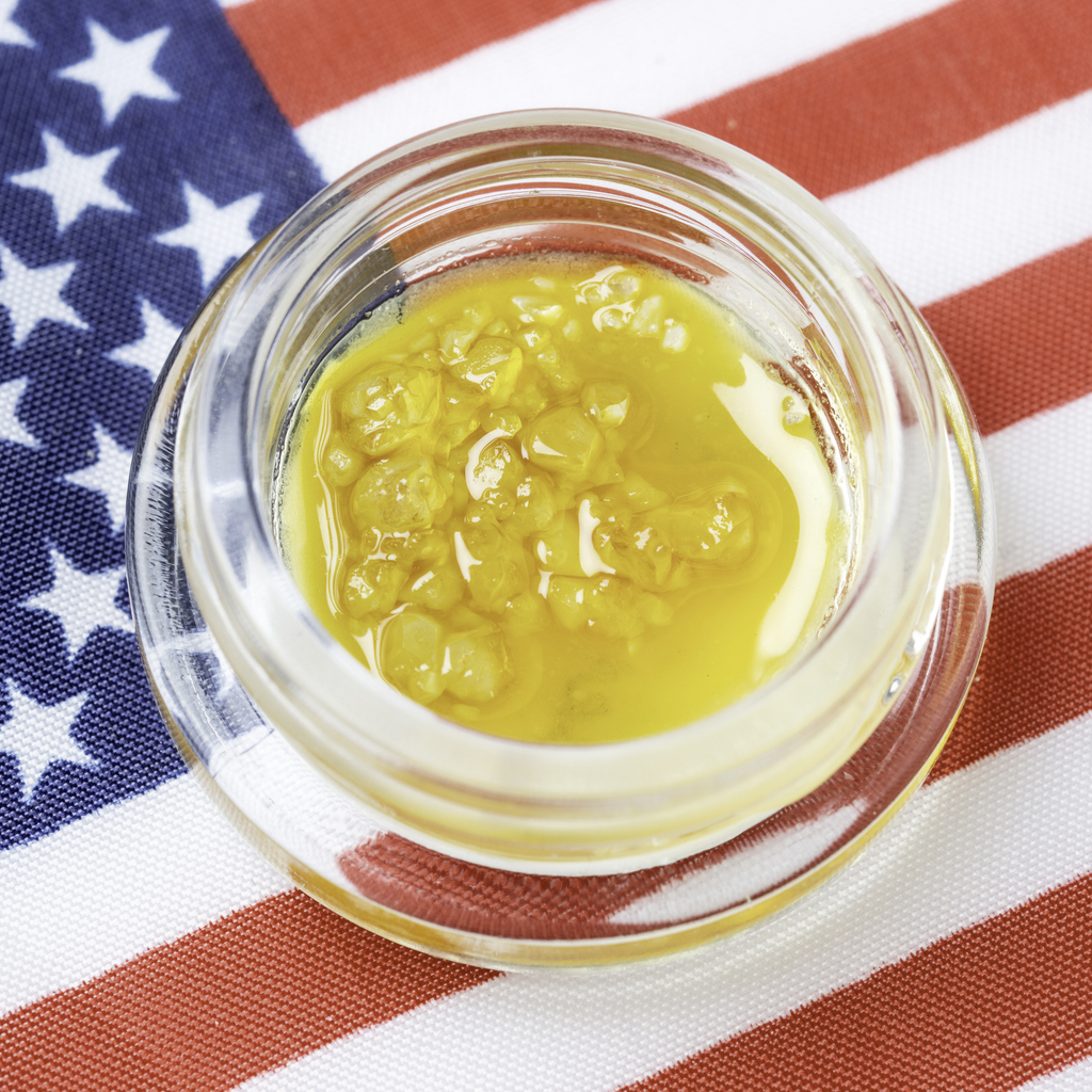 Premium Organic Cannabis Wax in Container on US flag background