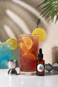A serene still life image featuring a refreshing CBD-infused drink. The beverage is presented in a stylish glass, highlighting its enticing color and texture. The composition subtly hints at the potential benefits of CBD, promoting relaxation and wellness. This image is perfect for those seeking to showcase the fusion of health-conscious trends with traditional beverage aesthetics.