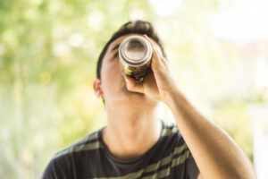 A man drinking a can.