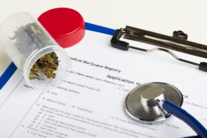 Medical marijuana in jar lying on prescription form near stethoscope. Cannabis recipe for personal use. Legal drugs concept