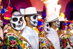 Painted dancers with Catrina skulls for dia de los muertos after the show on Palacio Municipal, Merida, Yucatan, Mexico