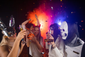 Happy people men and women mixed race dancing together on Halloween party